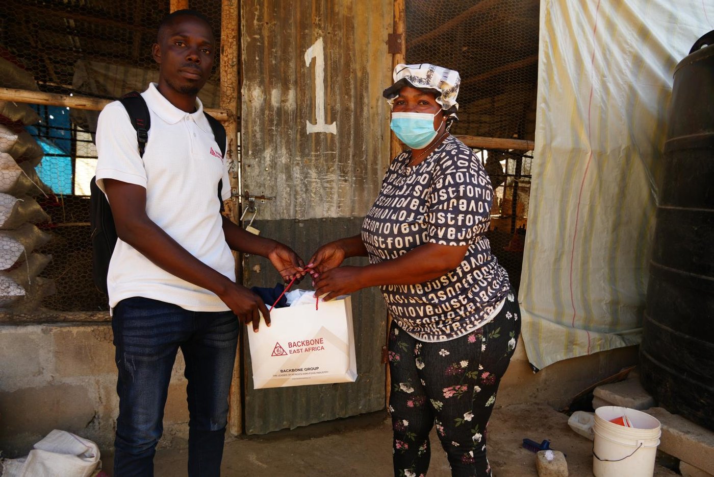 The Backbone Sales Representative presents a branded Backbone bag to the farmer as a token of appreciation during the farm visit.